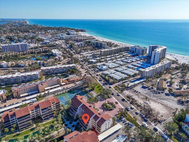 drone / aerial view featuring a beach view and a water view