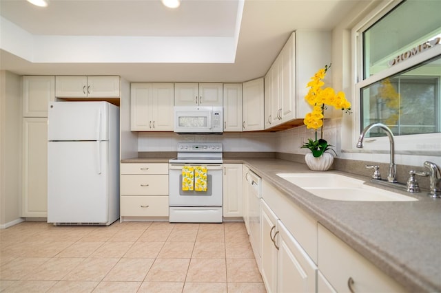 kitchen featuring sink, white appliances, and white cabinets