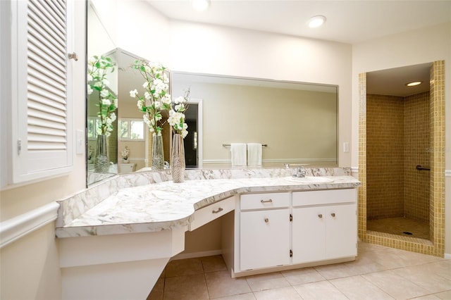 bathroom with vanity, tile patterned floors, and a tile shower