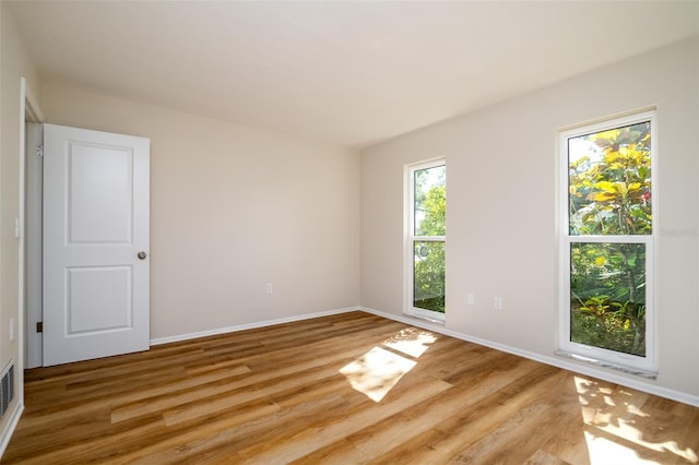 unfurnished room featuring light hardwood / wood-style floors