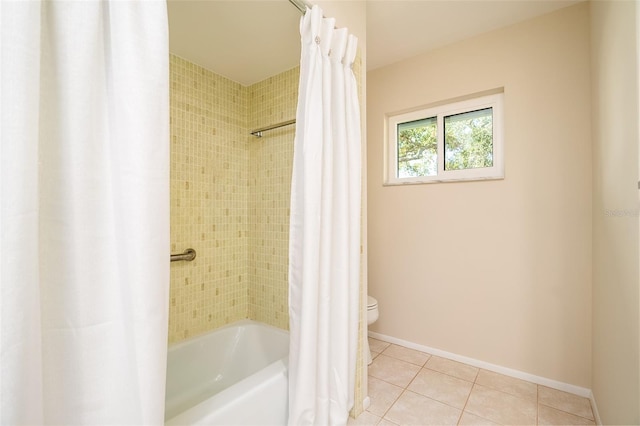 bathroom featuring shower / tub combo with curtain, toilet, and tile patterned flooring