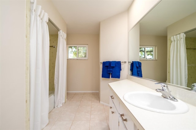 bathroom featuring tile patterned flooring, vanity, plenty of natural light, and shower / bath combo with shower curtain