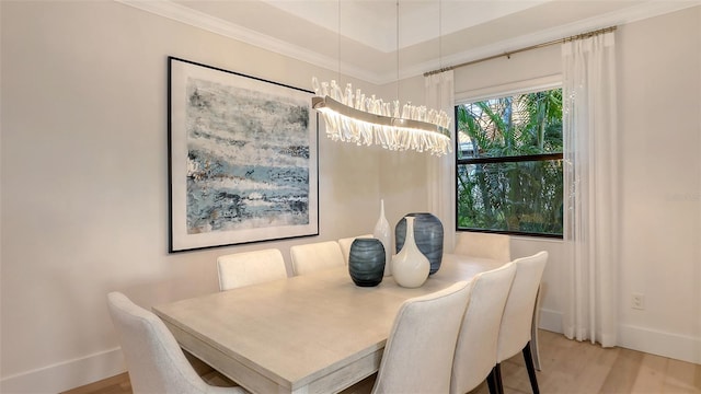 dining space featuring ornamental molding and light wood-type flooring