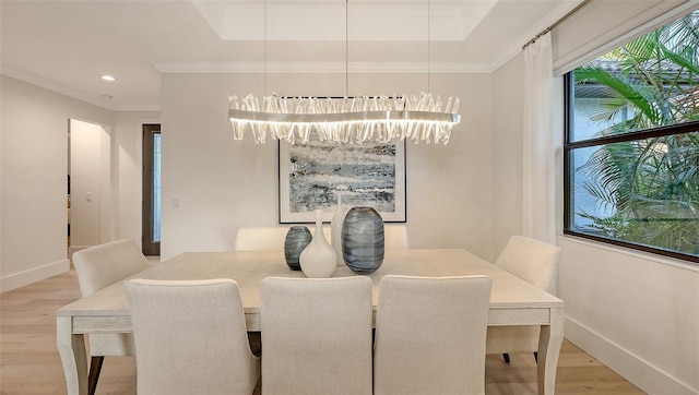 dining area with hardwood / wood-style flooring and ornamental molding