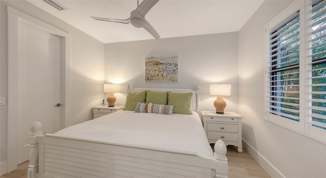 bedroom with light hardwood / wood-style flooring and ceiling fan