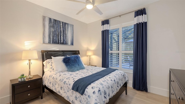 bedroom with ceiling fan and light wood-type flooring