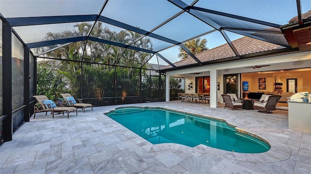 view of swimming pool featuring ceiling fan, an outdoor living space, a patio, and glass enclosure