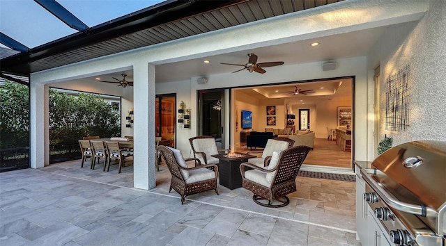 view of patio featuring a grill, ceiling fan, and a fire pit