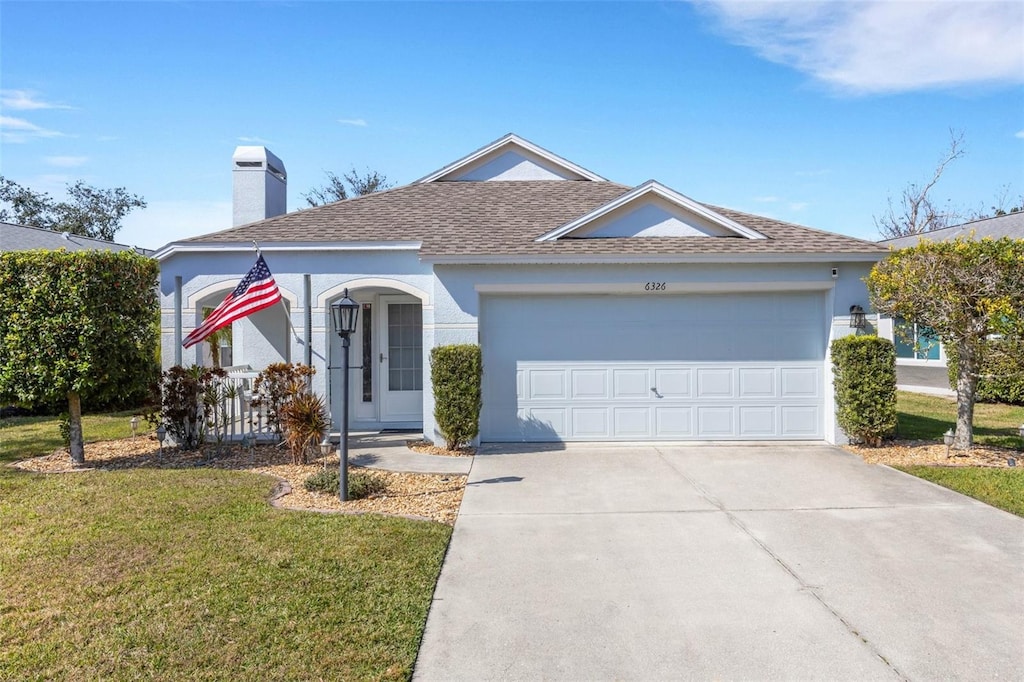 view of front facade featuring a garage and a front lawn