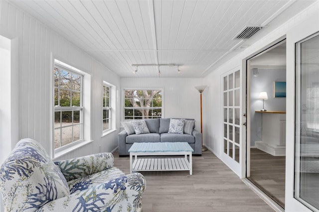 sunroom / solarium featuring french doors, track lighting, and visible vents