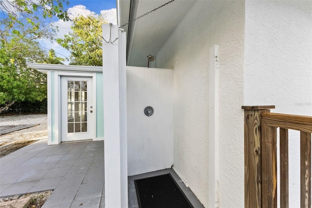 entrance to property featuring stucco siding