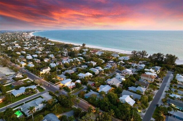 aerial view at dusk featuring a water view