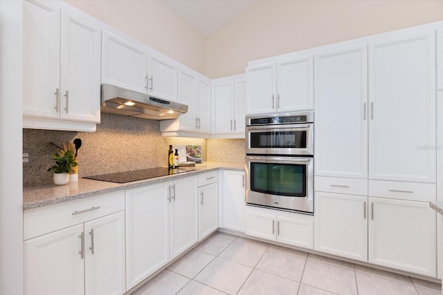 kitchen featuring black electric cooktop, double oven, and white cabinets