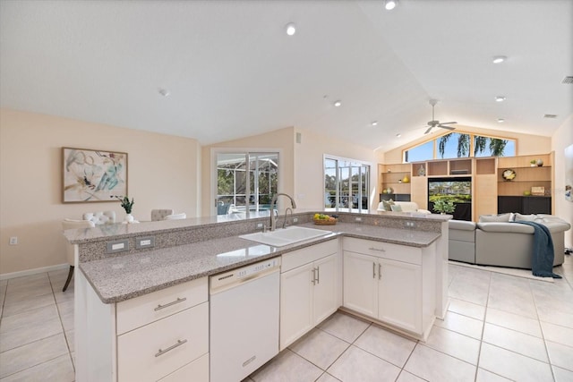 kitchen featuring sink, white cabinetry, light stone counters, dishwasher, and an island with sink