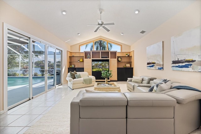 tiled living room featuring ceiling fan and vaulted ceiling