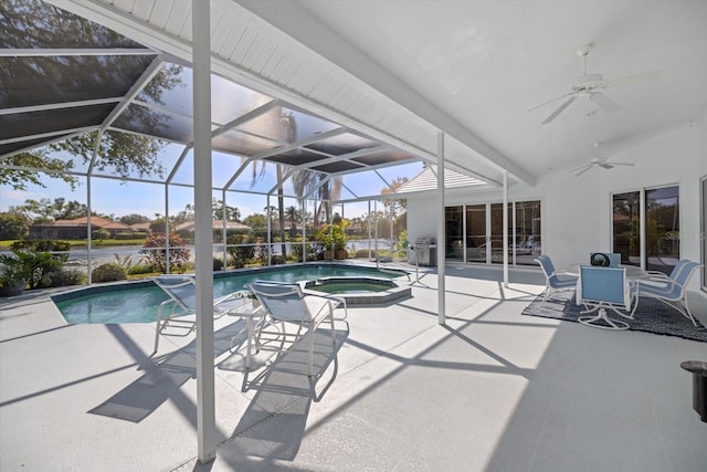 view of swimming pool with a patio area, an in ground hot tub, ceiling fan, and glass enclosure