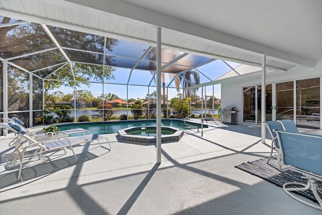 view of pool featuring an in ground hot tub, a water view, a patio area, and glass enclosure