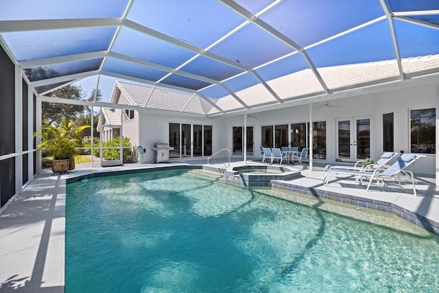 view of swimming pool featuring french doors, a patio area, area for grilling, glass enclosure, and an in ground hot tub