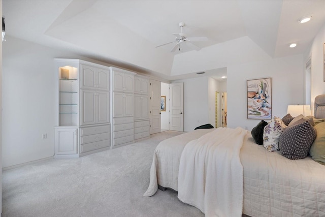 carpeted bedroom featuring ensuite bath, vaulted ceiling, and ceiling fan