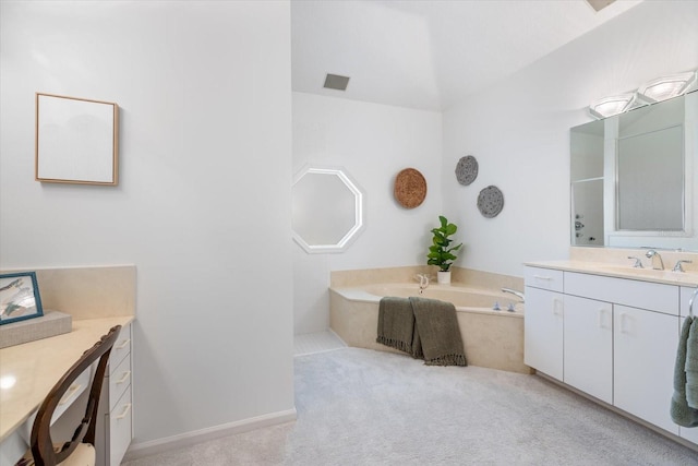 bathroom with a washtub and vanity