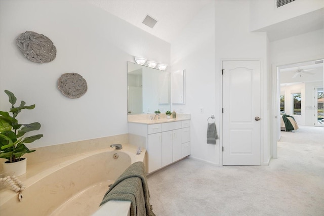 bathroom with vanity and a washtub