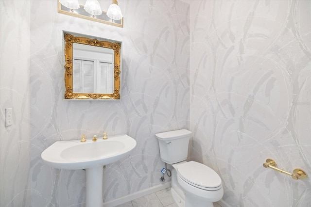 bathroom with tile patterned flooring and toilet