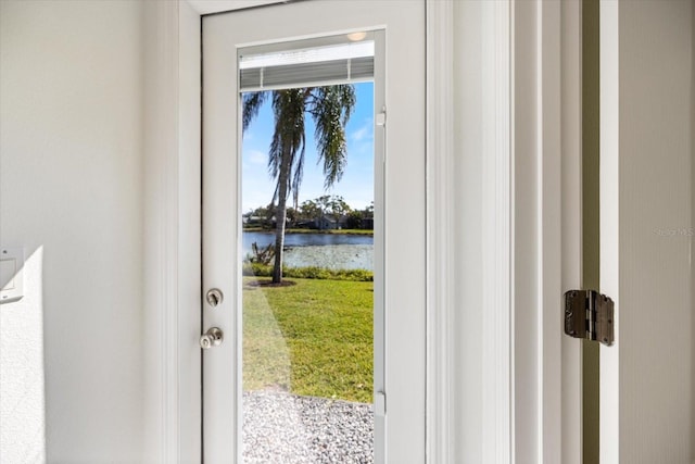 doorway to outside with a water view