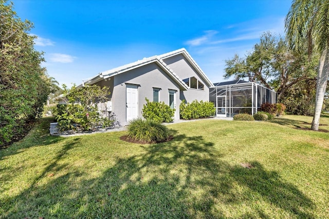 exterior space featuring a lanai and a lawn