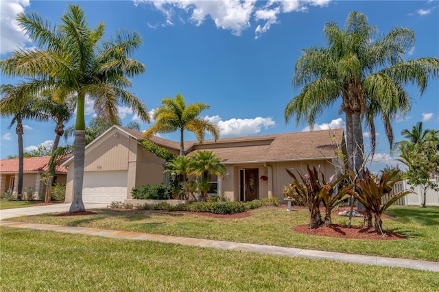 ranch-style home with a front yard, an attached garage, and driveway