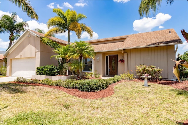 ranch-style home featuring an attached garage, driveway, and a front lawn