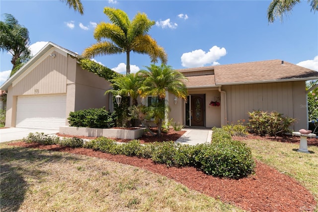 ranch-style home featuring concrete driveway and an attached garage