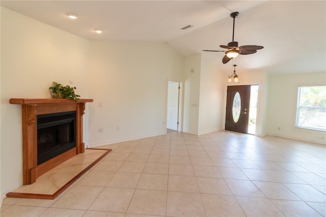 unfurnished living room with visible vents, light tile patterned flooring, a fireplace, lofted ceiling, and ceiling fan