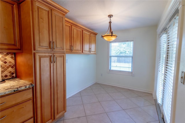 interior space with light tile patterned floors and baseboards