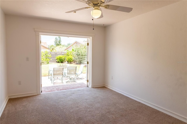 unfurnished room with carpet flooring, baseboards, and ceiling fan