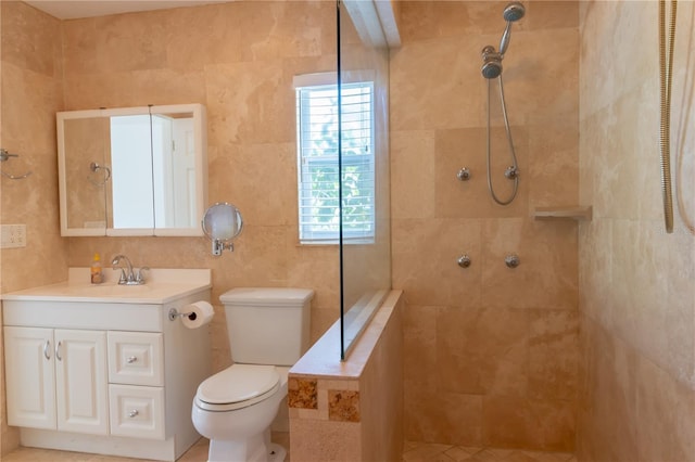 full bath with toilet, tiled shower, and vanity