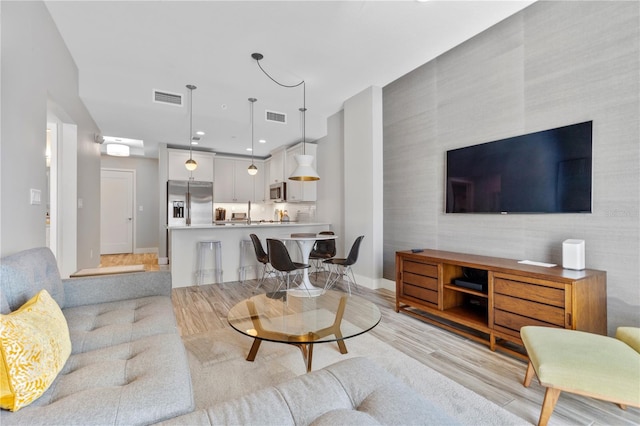 living room with light hardwood / wood-style floors