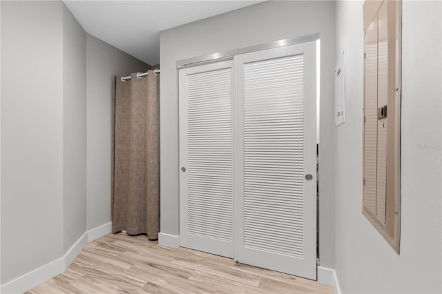 bedroom with light hardwood / wood-style flooring and a closet