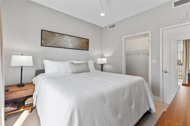 bedroom featuring light colored carpet and a closet