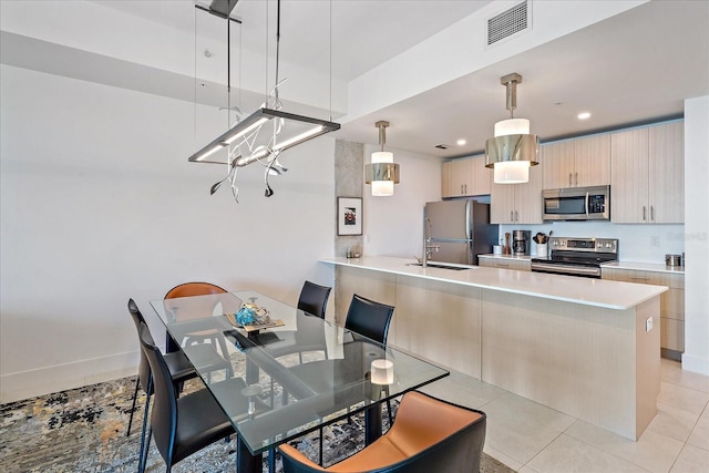 tiled dining room featuring sink