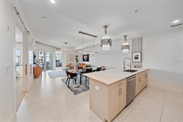 kitchen with dishwasher, sink, hanging light fixtures, kitchen peninsula, and light brown cabinets