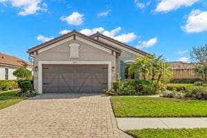 view of front of property with a garage and a front yard