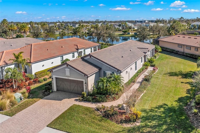 drone / aerial view featuring a water view and a residential view