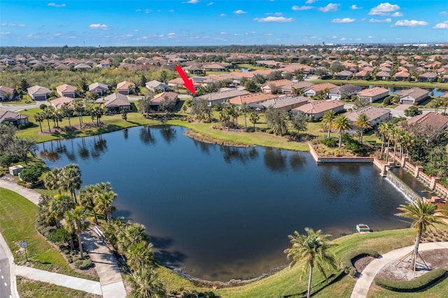 drone / aerial view featuring a water view and a residential view