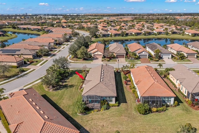 drone / aerial view with a water view and a residential view