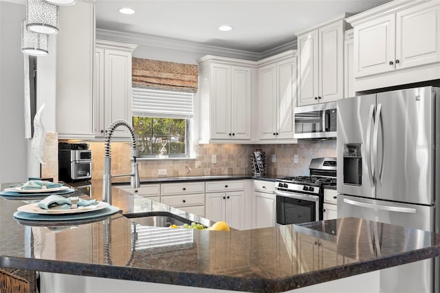 kitchen with stainless steel appliances, a peninsula, white cabinetry, tasteful backsplash, and crown molding