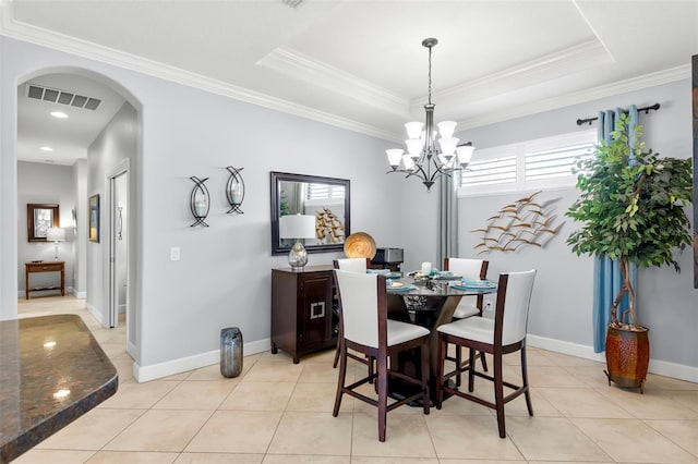 dining area with visible vents, a tray ceiling, arched walkways, and crown molding