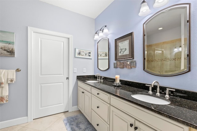 bathroom featuring tile patterned flooring, a sink, baseboards, and double vanity