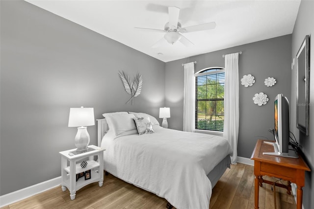 bedroom featuring baseboards, ceiling fan, and hardwood / wood-style floors