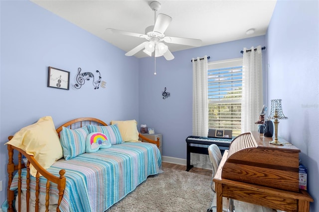 bedroom featuring baseboards, a ceiling fan, and wood finished floors