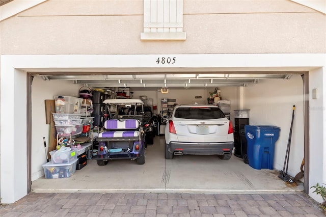 garage featuring decorative driveway